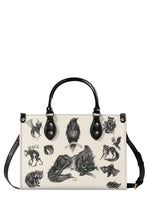 Black gothic handbag with illustrated forest creatures