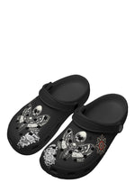 Angled perspective showing tattoo-inspired death moths and snake motifs on slippers