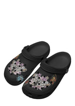 Angled front view of death moth slippers with purple flowers and bone motifs