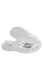White sole view of death moth gothic slippers with black floral patterns