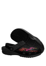 Sole view of black fuzzy slippers with grip bottom