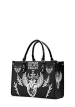 Side view of gothic bag with winged heart and skull moth details