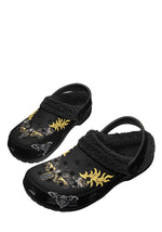 Flat lay of Death Flame slippers with bold tattoo print and plush lining