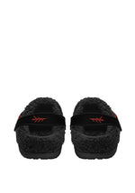 Back view of cozy slippers with tattoo moth design