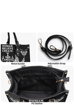 Close-up of gold-tone hardware and detachable strap on gothic handbag