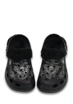 Front view of black fuzzy slippers with skull moth and chain design