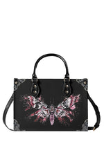 black gothic handbag with pink splatter-style death moth illustration and floral corner details