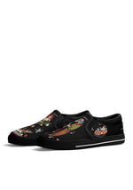 Side view of black slip-ons featuring dancing dalmatians and biker girl tattoo design