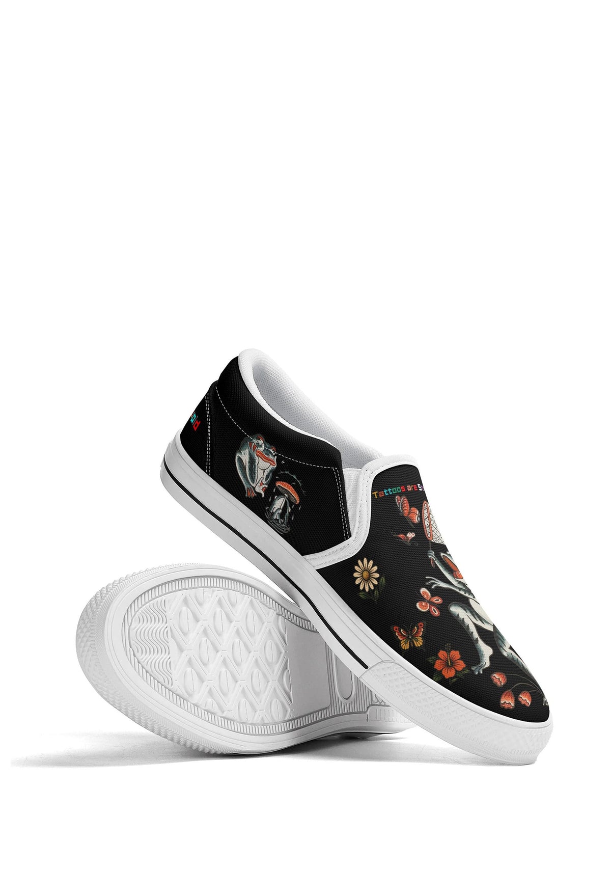 Display shot of white-edged slip-ons showing sole texture and detailed frog and butterfly design