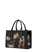 Side view of gothic tattoo-style handbag with surreal dog and girl scenes