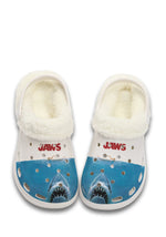 Front view of white fuzzy JAWS slippers with great white shark graphic