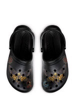 Black gothic slides with death moths, roses, and skulls, viewed from above