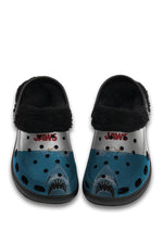 Front view of black fuzzy shark slippers with JAWS logo and great white illustration