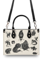 Back of the bag with horned beast and black handle detail