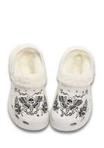 Front view of white slippers with floral skull moth design